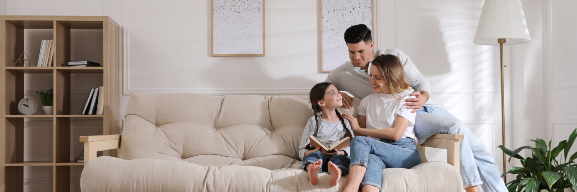 Happy family on sofa and puppy in living room