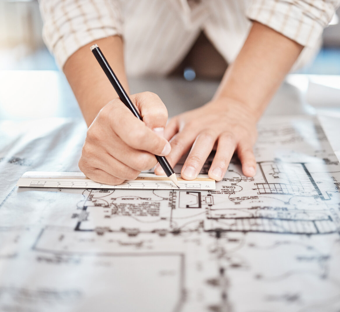 Architect drawing building floor plan, design blueprint map and engineer drafting structure on table paper. Real estate development work office construction and industrial wall safety ruler.